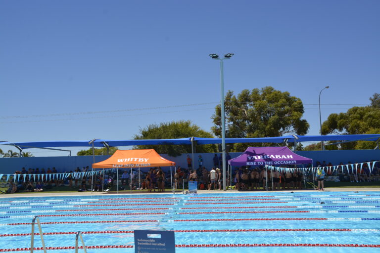 Swimming carnival at the pool with house marquees