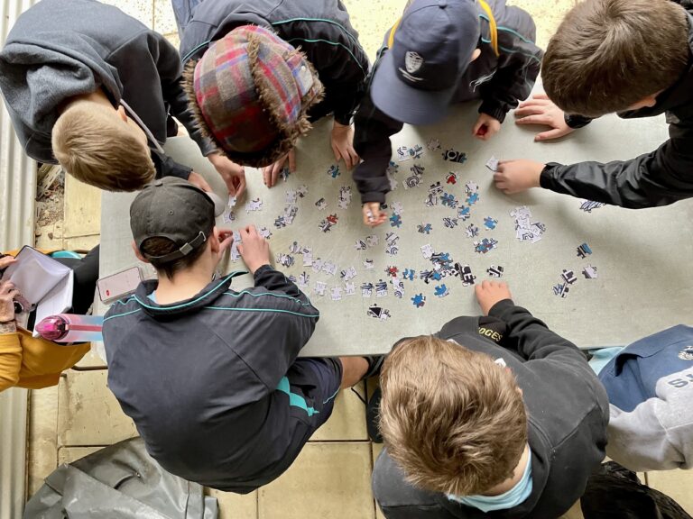 Students gathered around a table during a group activity