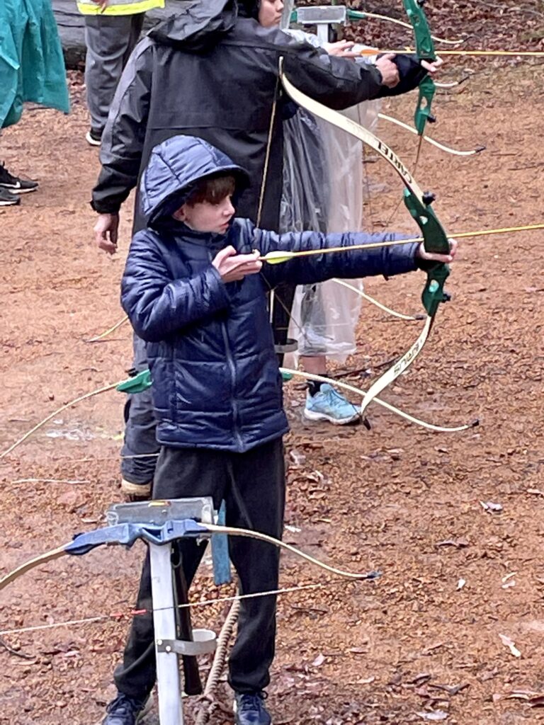 Student practising archery outdoors