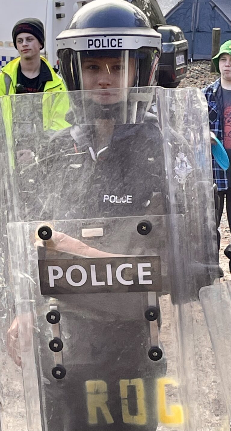 Student in police protective gear during a Police Rangers activity
