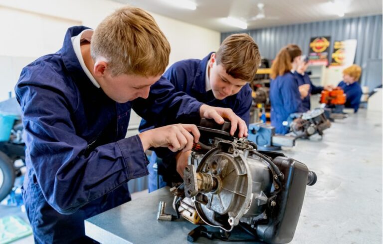 Student working on an engine in the automotive workshop