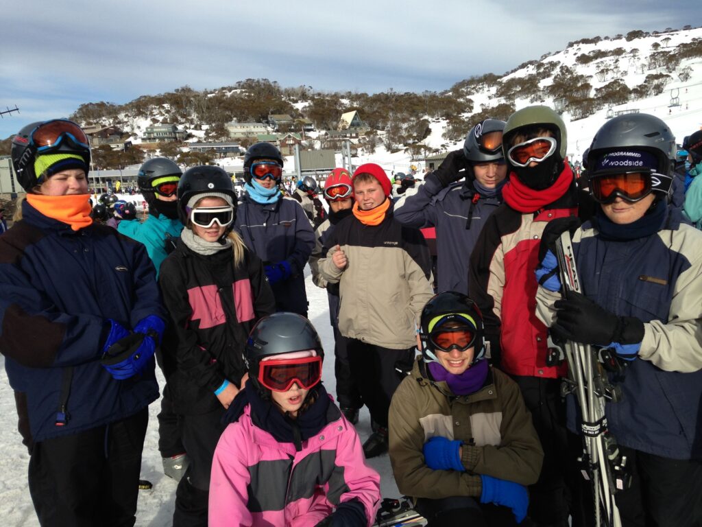 Students in ski gear on the snow during the Canberra trip