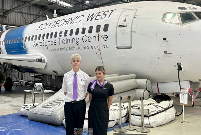 Students standing in front of an aircraft at an aviation training centre
